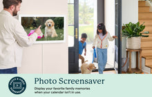 Load image into Gallery viewer, Man setting a family photo screensaver on the Skylight 27-inch wall-mounted digital calendar while kids enter with their dog.
